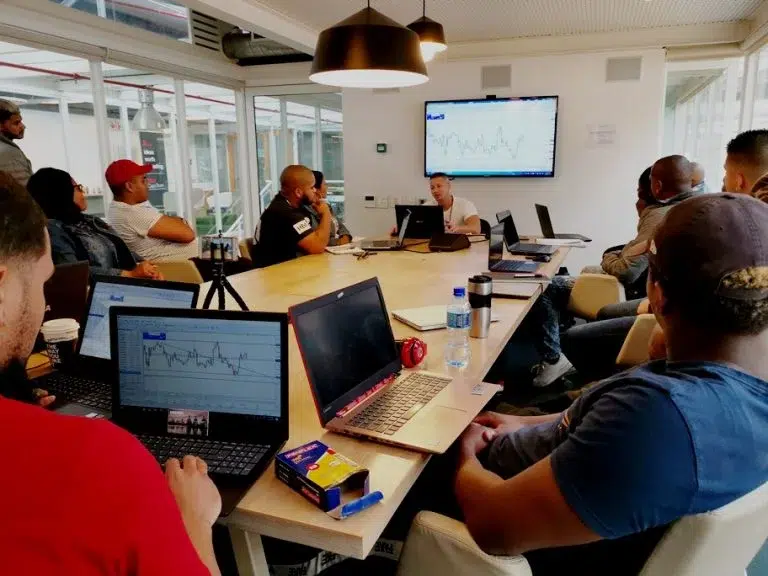 Students learning trading at their stations